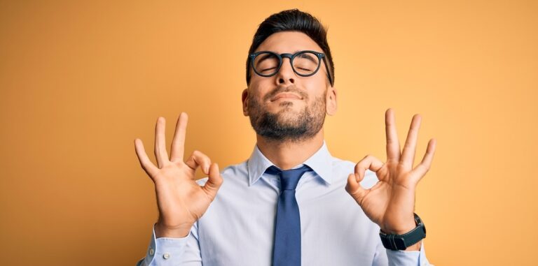 Young,Handsome,Businessman,Wearing,Tie,And,Glasses,Standing,Over,Yellow/